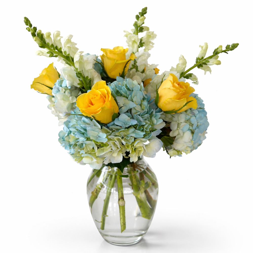 Elegant floral arrangement with yellow roses and hydrangeas